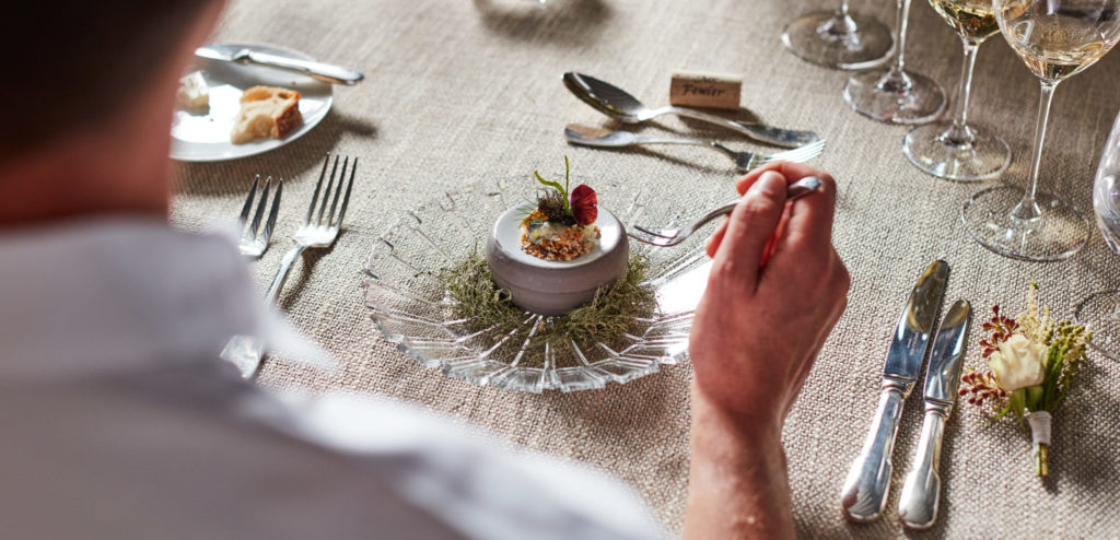 Man in front of table at winery dinner