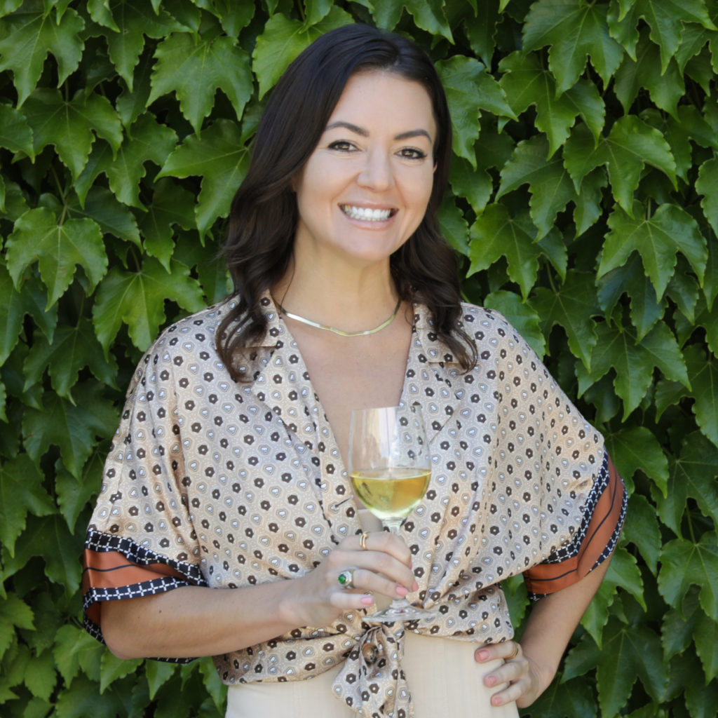 woman standing in front of green ivy wall