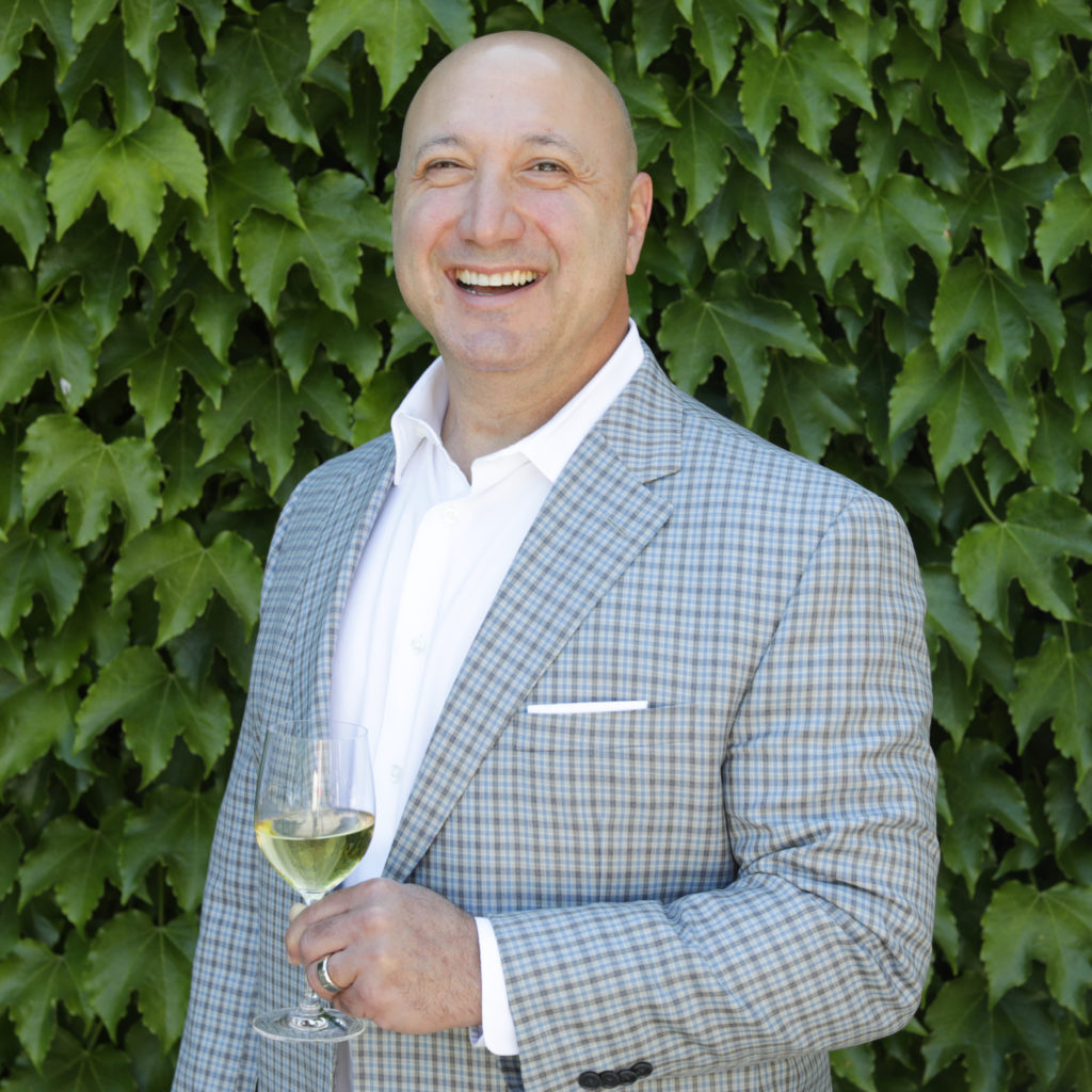 man standing in front of green ivy wall