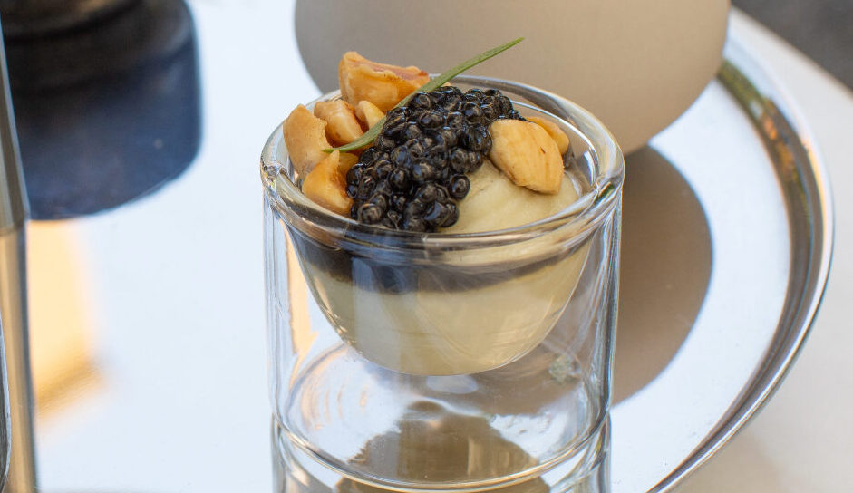 silver tray on table with small bites including brentwood corn and caviar in glass dish