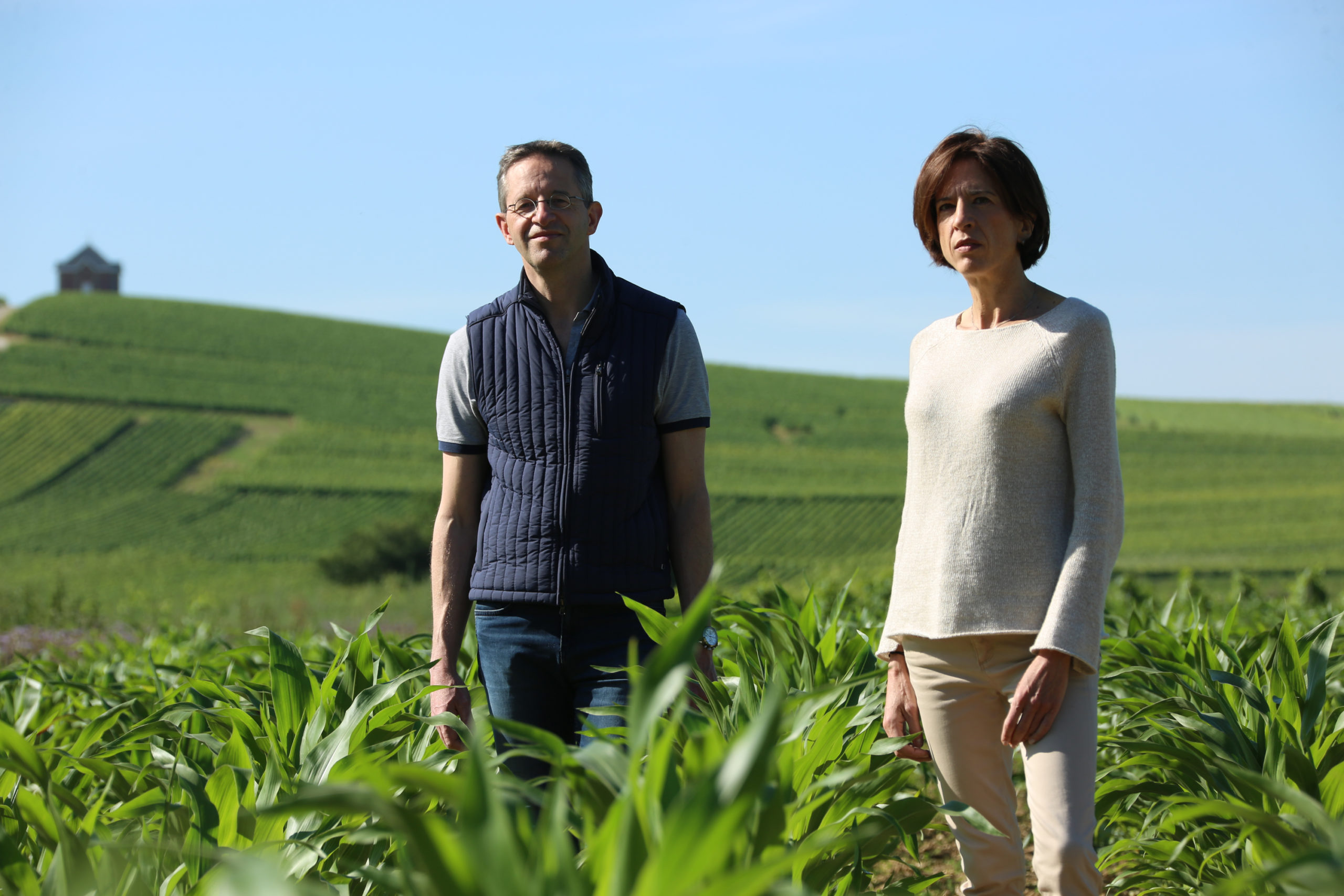 Anne and Antoine Malassagne standing in Champagne vineyards AR Lenoble