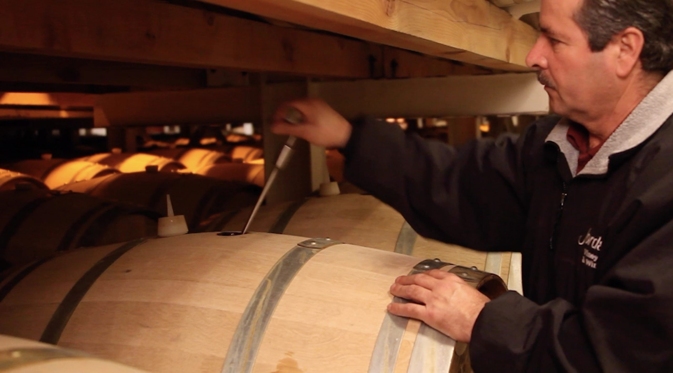 Person performing Bâtonnage, the stirring of chardonnay’s lees