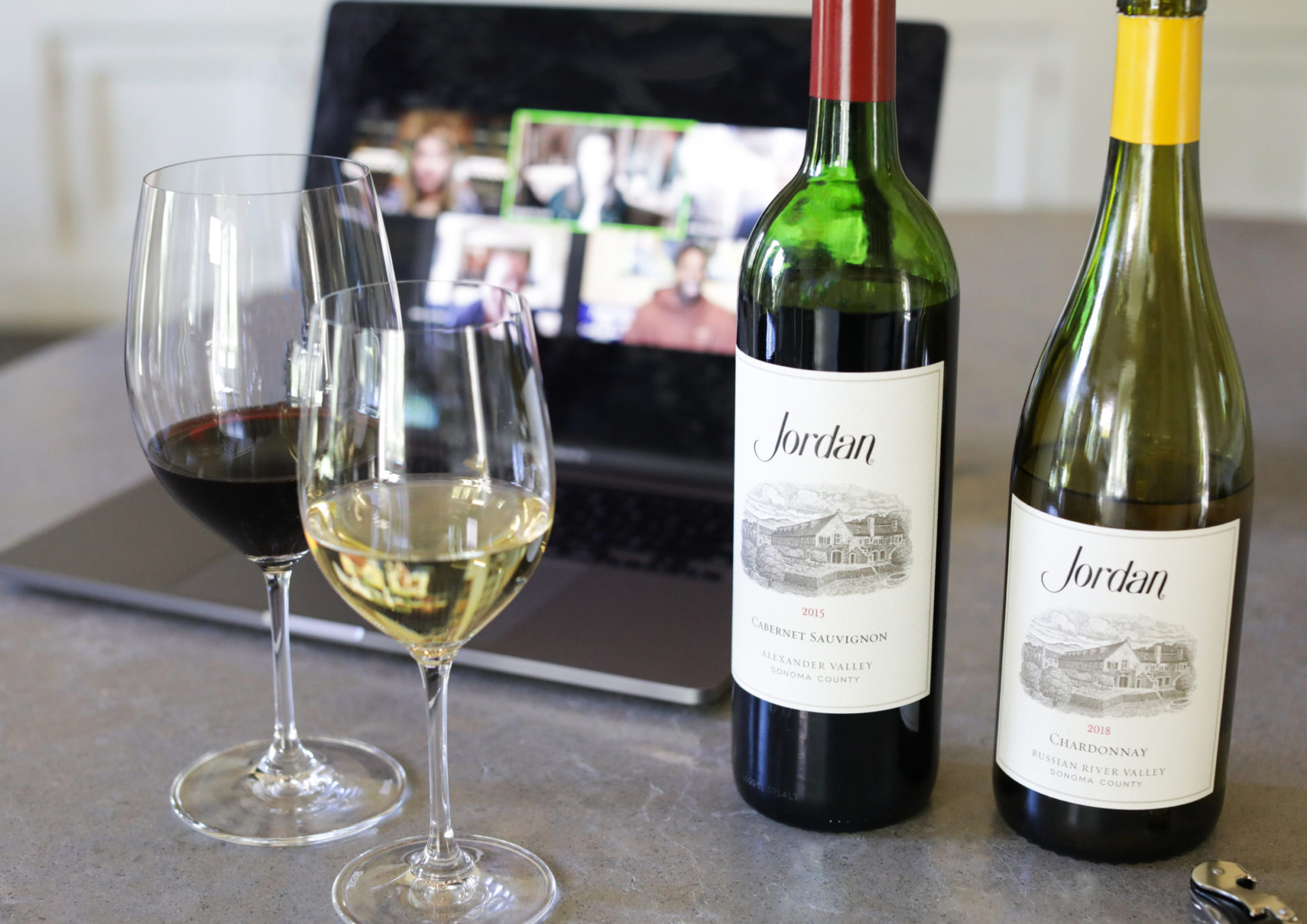 jordan cabernet and chardonnay bottles in front of laptop for virtual tasting