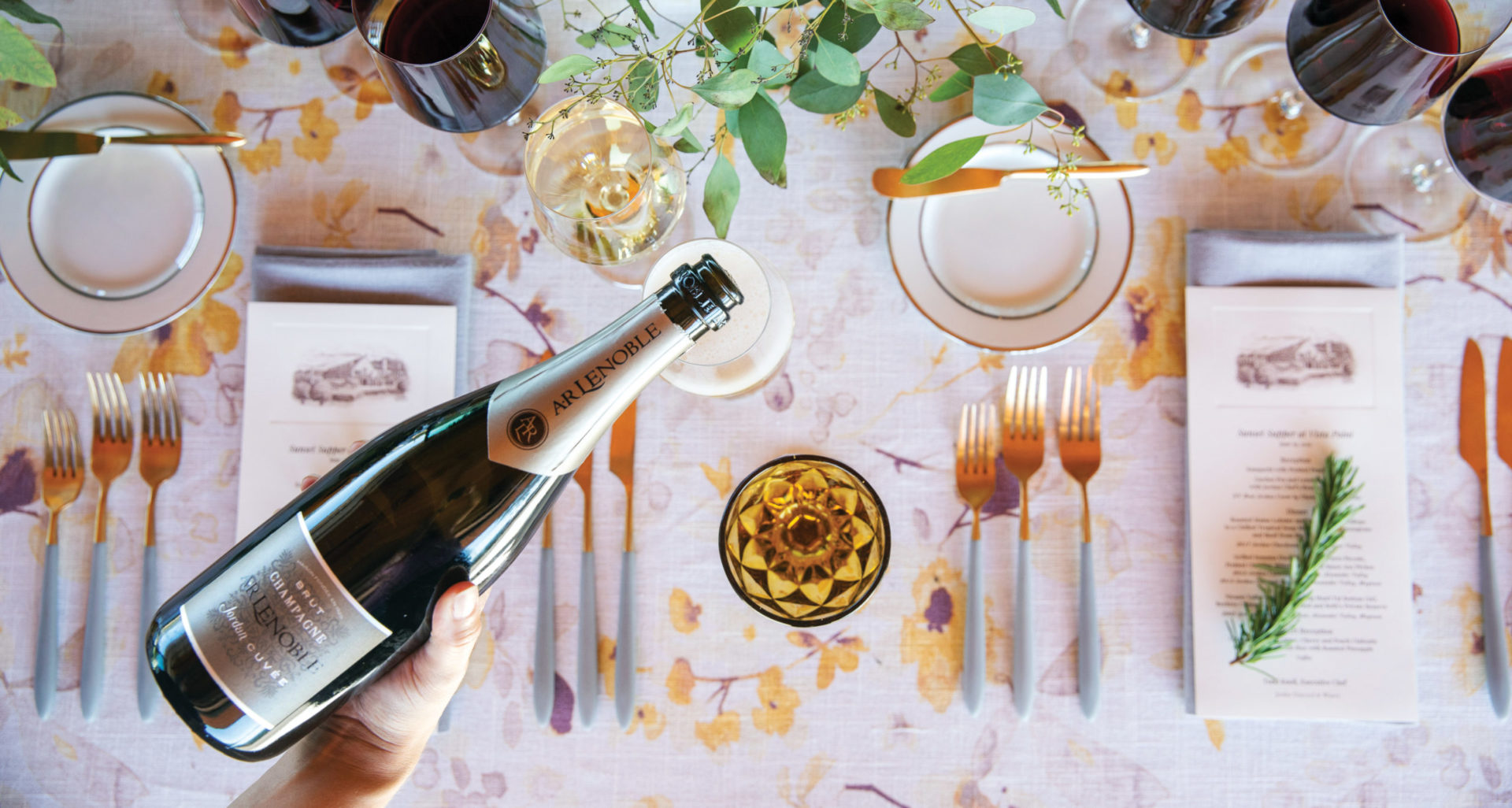 Jordan Cuvee pouring into wine glass over dinner table