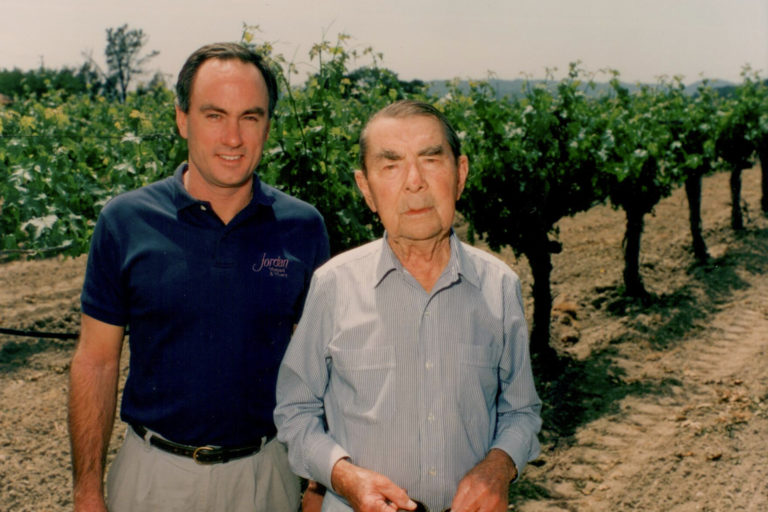 Rob Davis and Andre Tchelistcheff standing in a vineyard at Jordan Winery