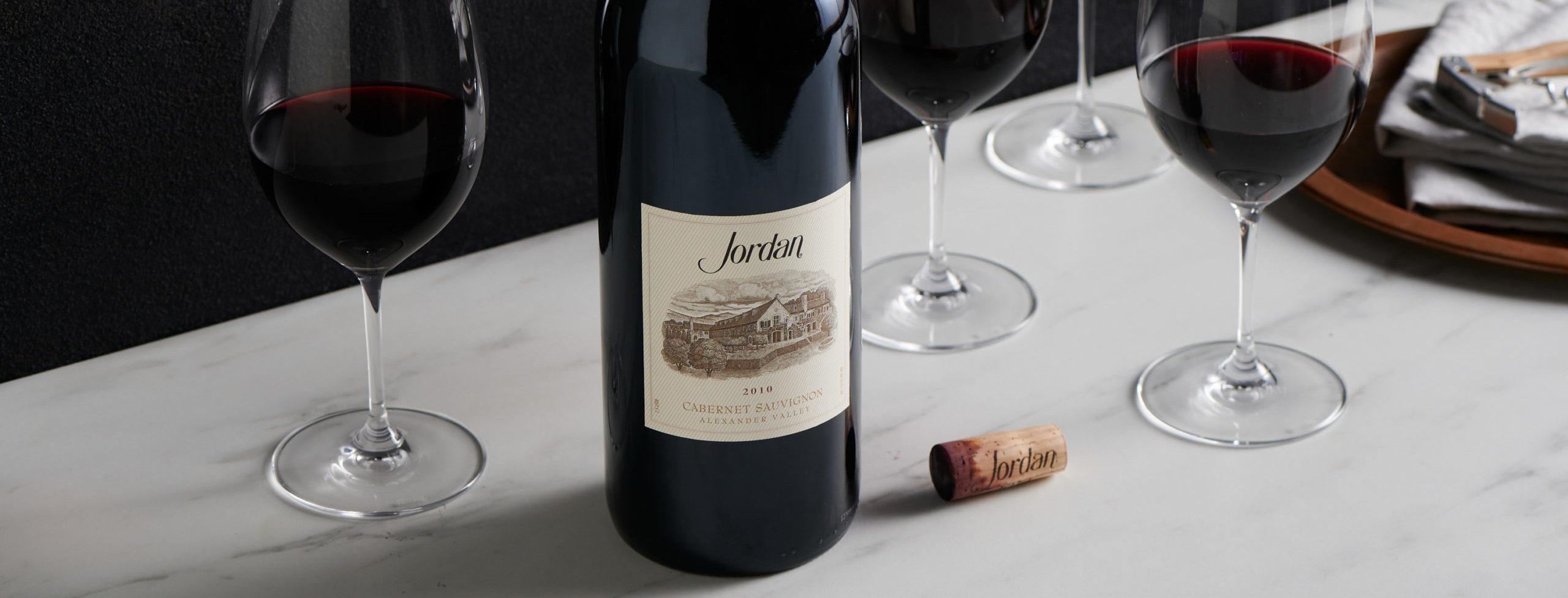 Bottle and glasses of Jordan Cabernet Sauvignon