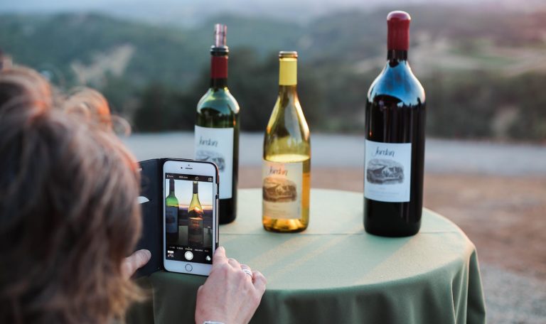 Person taking photo of Jordan Cabernet Sauvignon and Jordan Chardonnay