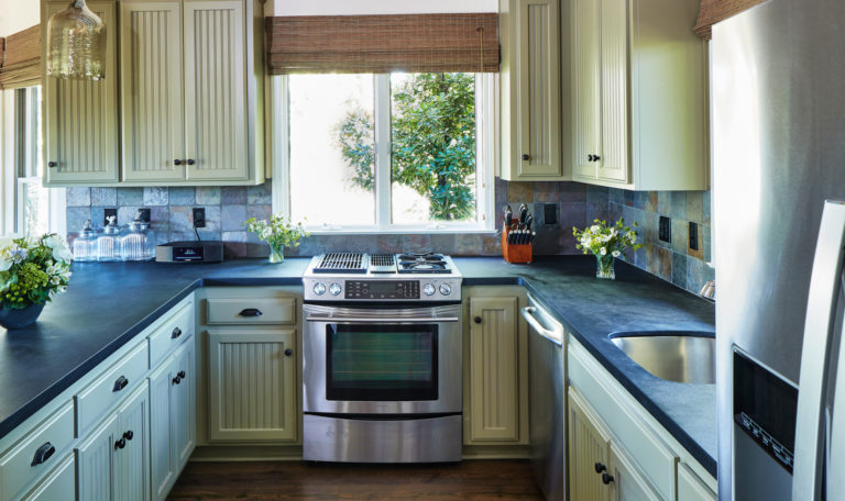 guesthouse kitchen with green cabinets