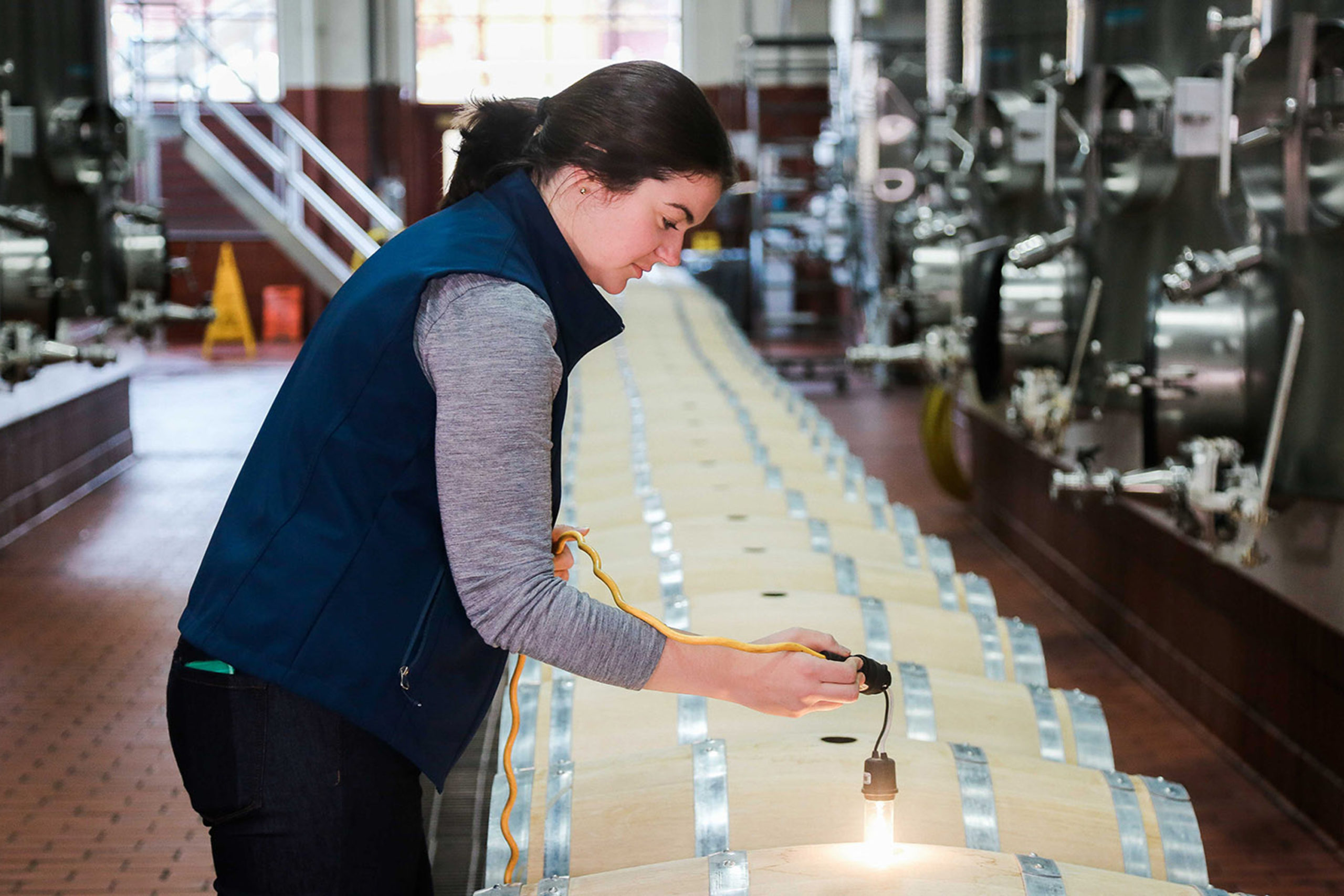 Winemaker Maggie Kruse inspecting barrels