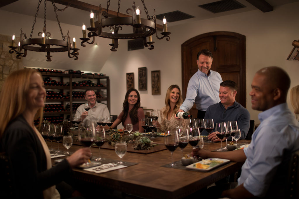 Jordan Winery Cellar Room with people tasting cabernet around table