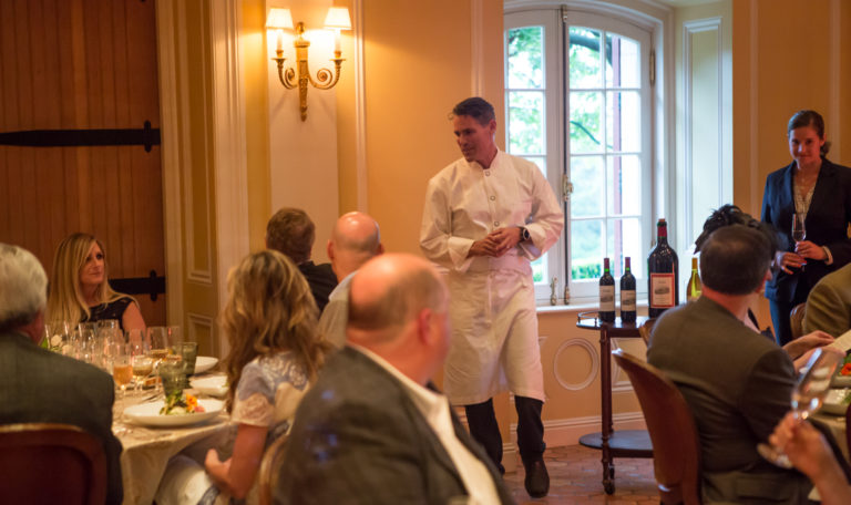 A chef checks in with guests at their table in Jordan Winery's tasting room.