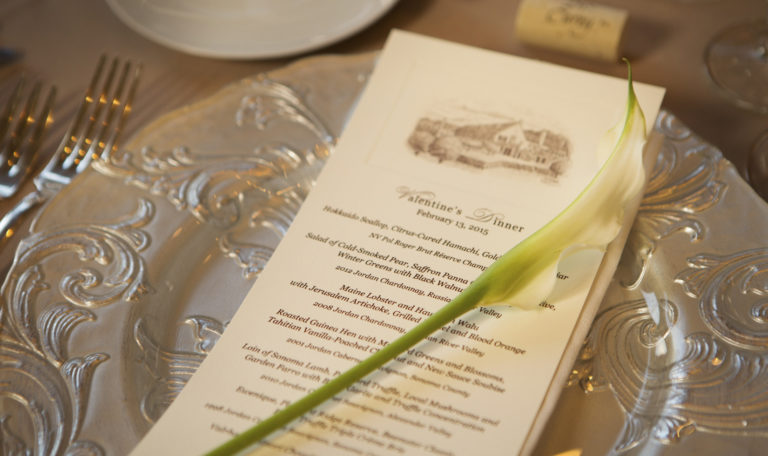 Jordan's 2015 Valentine's Dinner menu on a decorative silver plate with a young white lily.