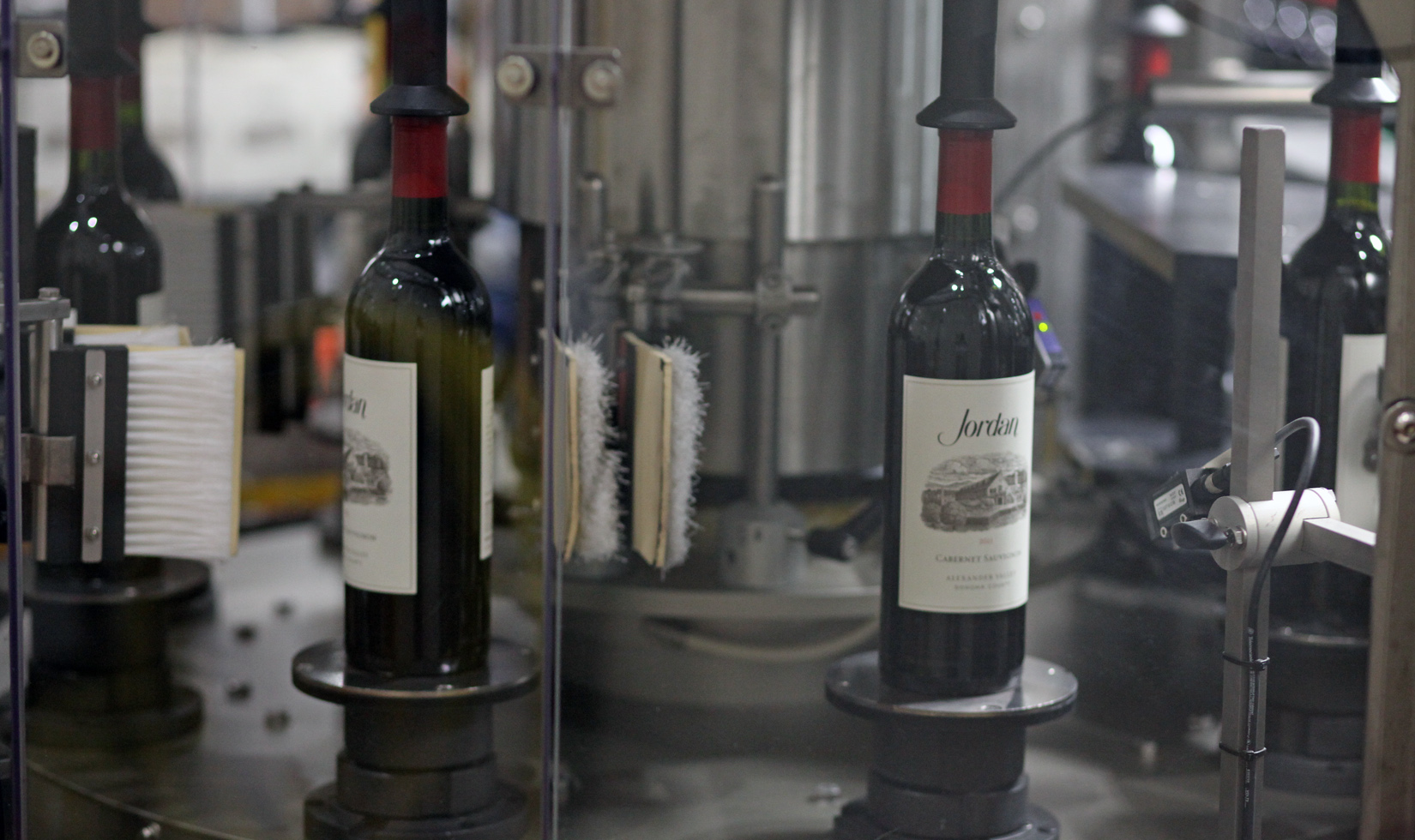 Labels being applied to bottles of Jordan Cabernet Sauvignon on the wine line.