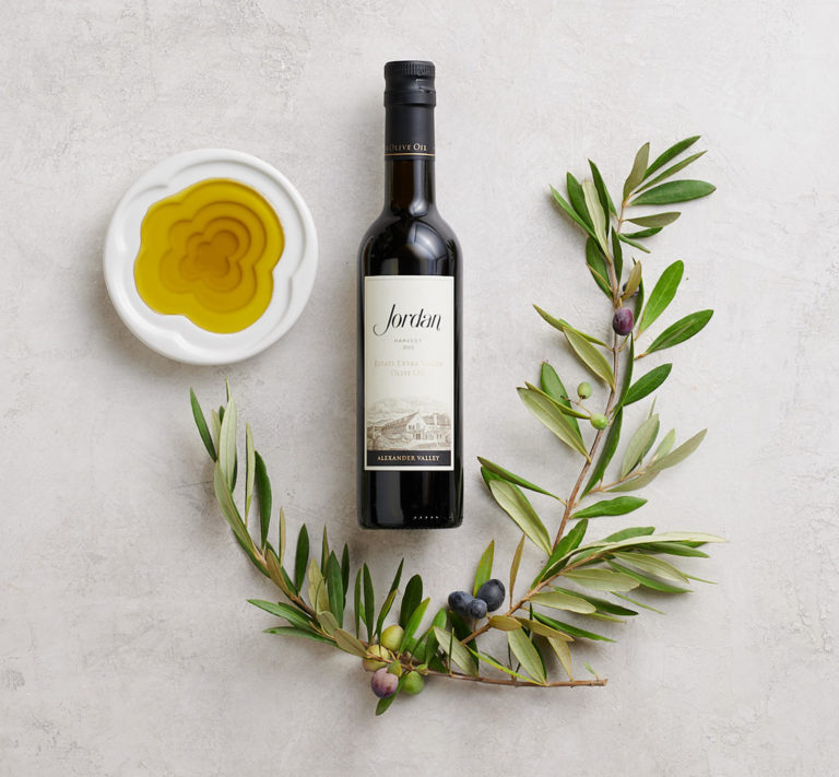 Jordan Olive Oil bottle on table with dipping dish and olive tree branch