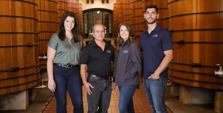 group photo of four people in oak tank room