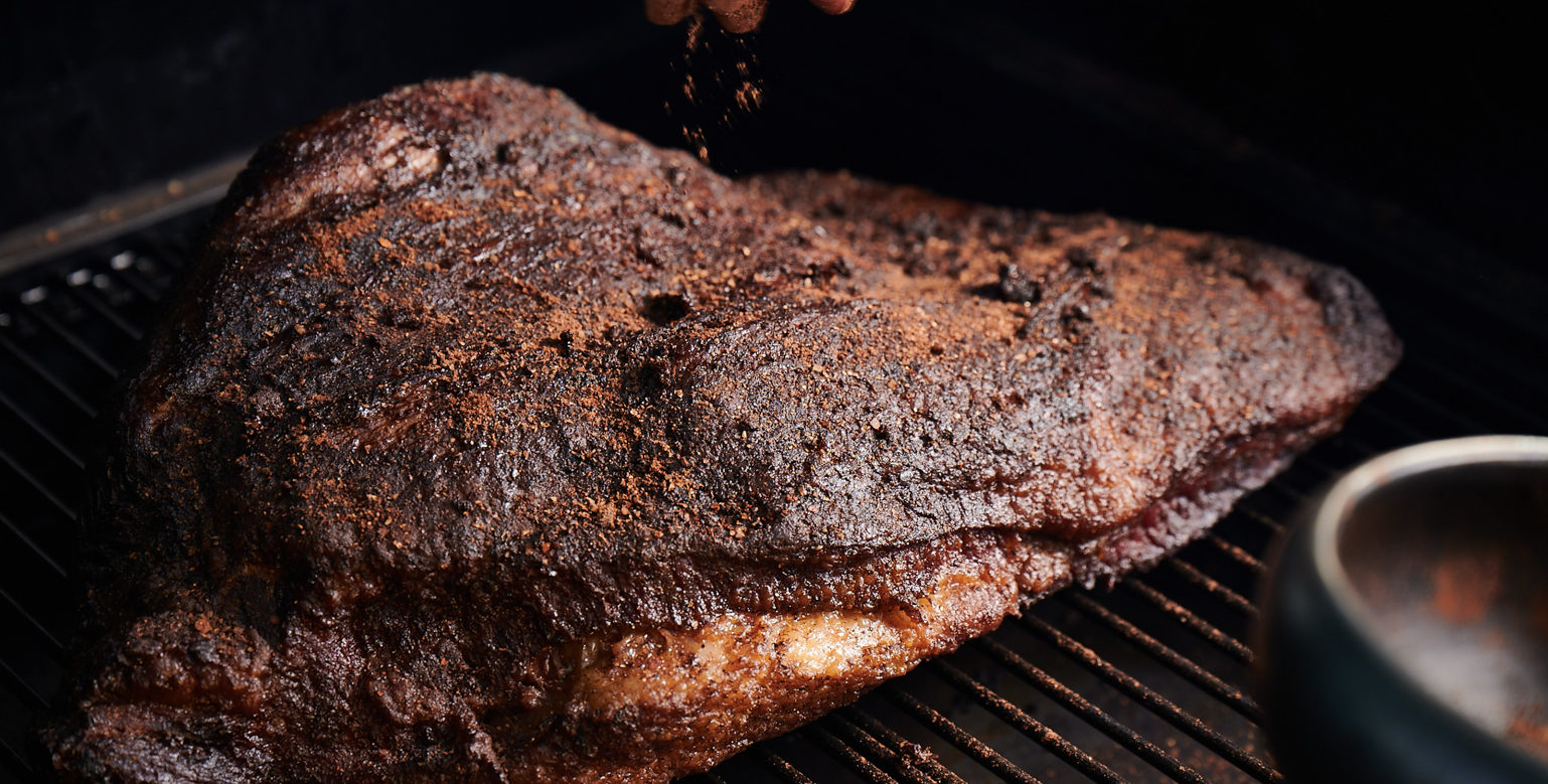 dry rub on large cut of brisket meat