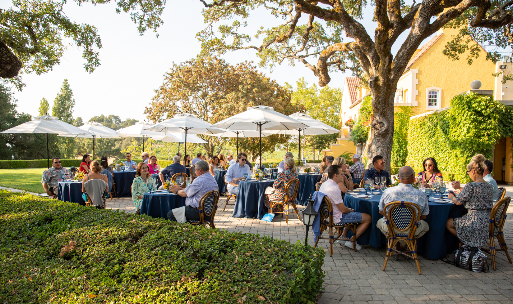 people eating dinner at private tables on terrace