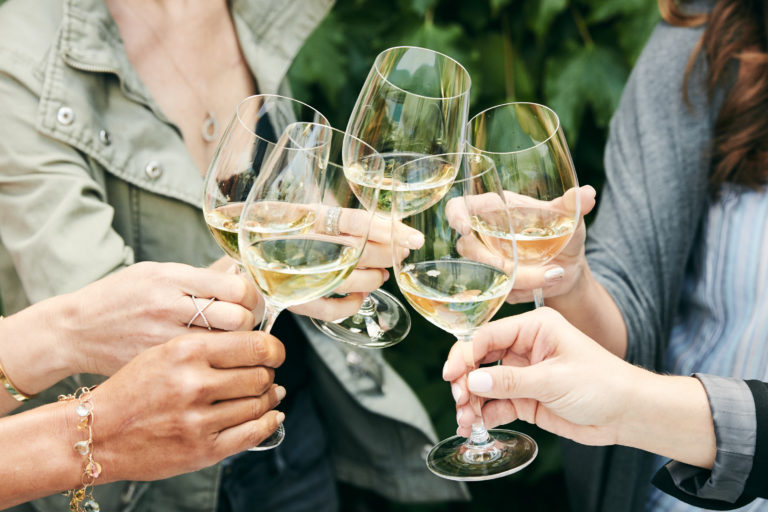 group of chardonnay wine glasses toasting