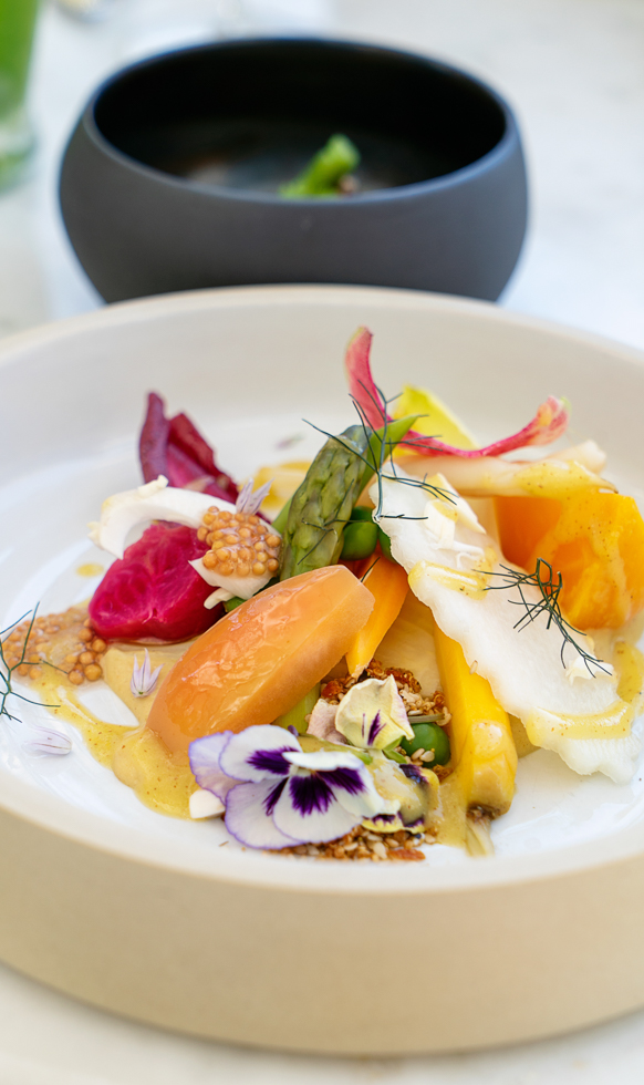 yellow and orange beets and edible flowers on lunch plate