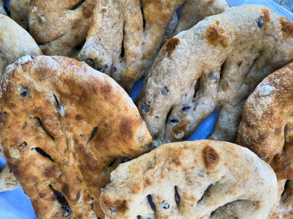 loaves of baked bread on white linen