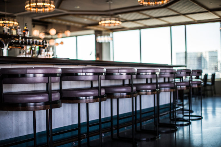 purple and black barstools pushed up against bar