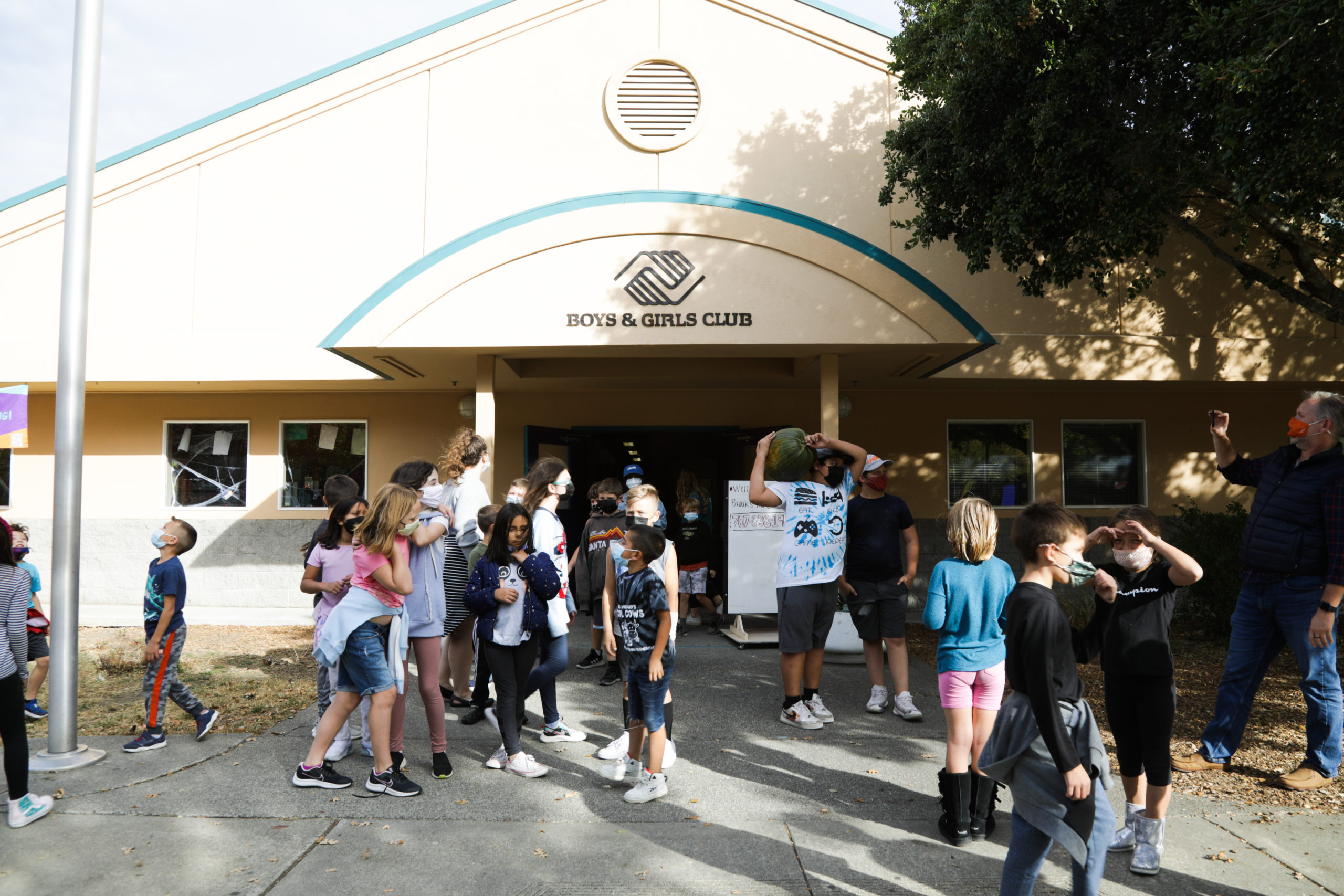 Group of children standing outside the Boys & Girls Club building in Healdsburg, California. 