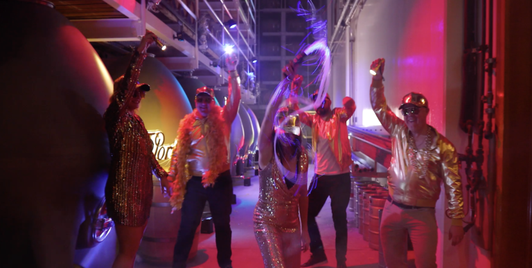 group of men and women dancing with multi-colored lights