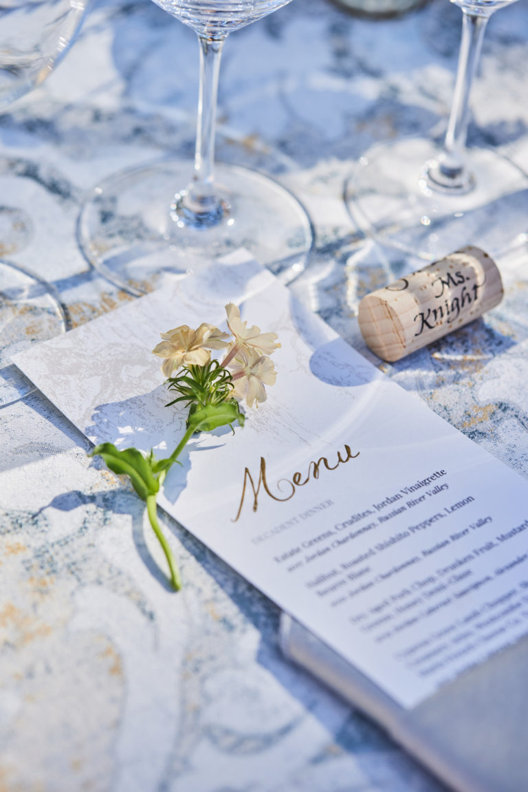 outdoor dinner menu with floral and table linen