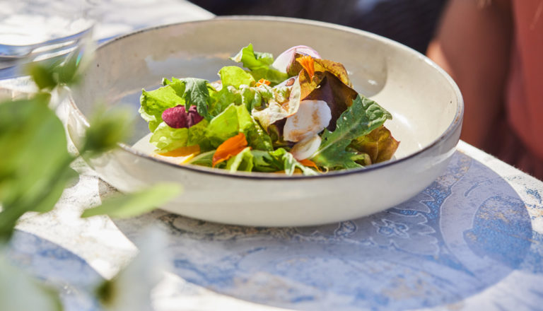 Fresh salad greens in neutral bowl