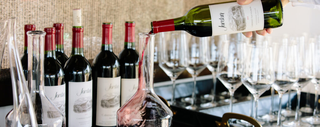 bottle of cabernet sauvignon being poured into a decanter