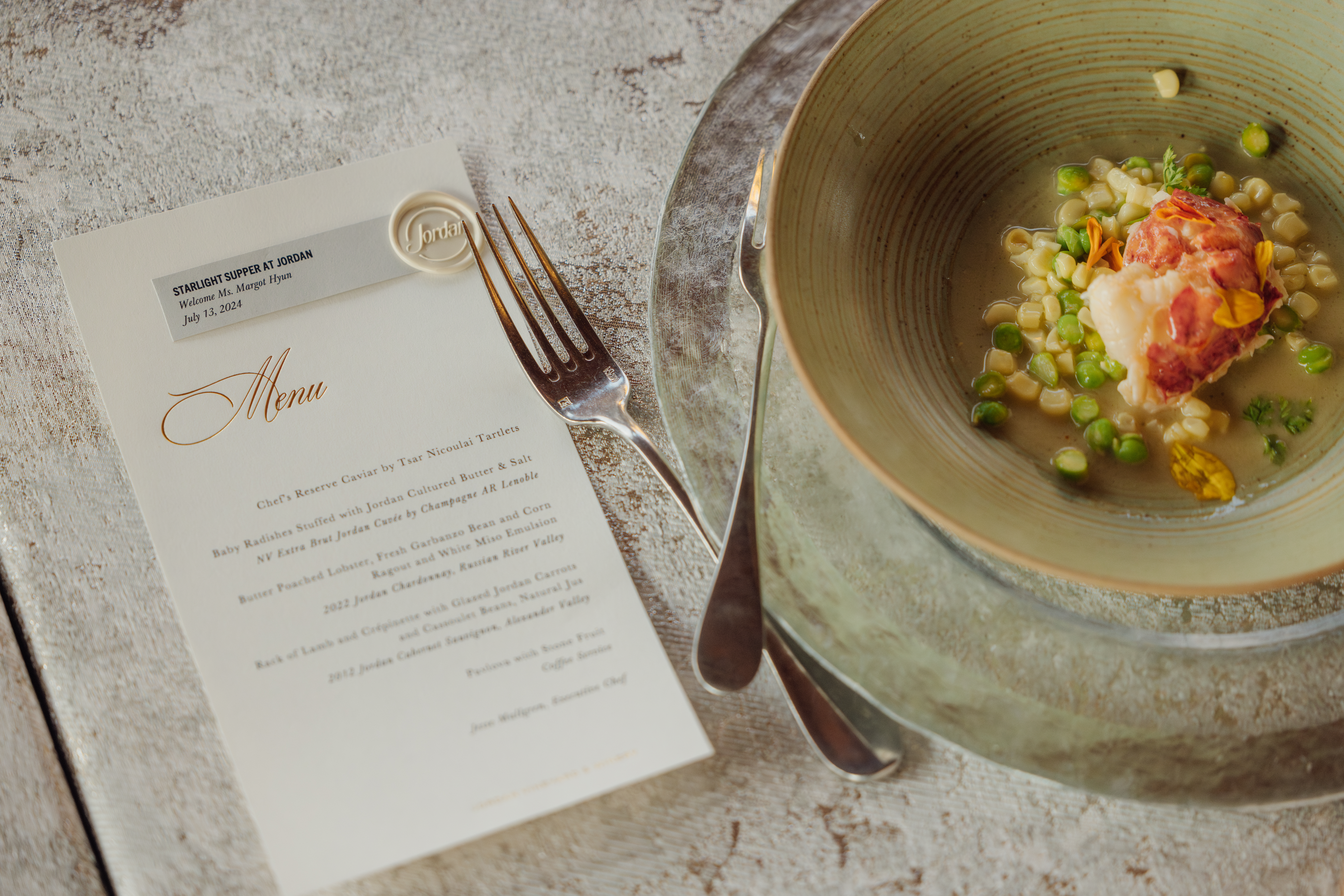 lobster dish with menu and fork on table