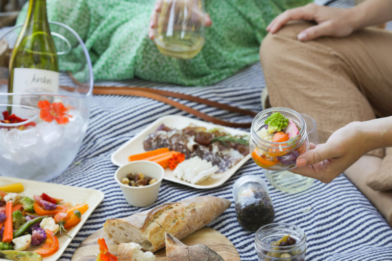 pickled vegetables in mason jar on picnic blanket