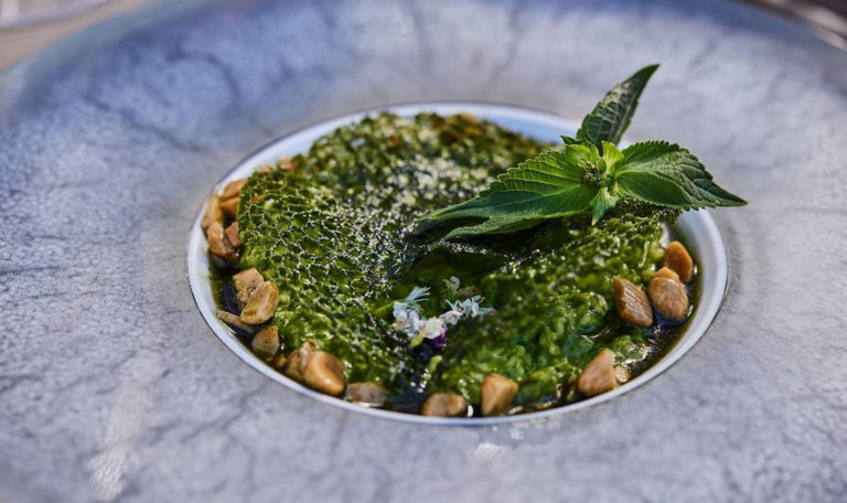 close-up on pesto pasta dish with mint leaf