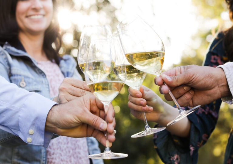group toasting with glasses of chardonnay