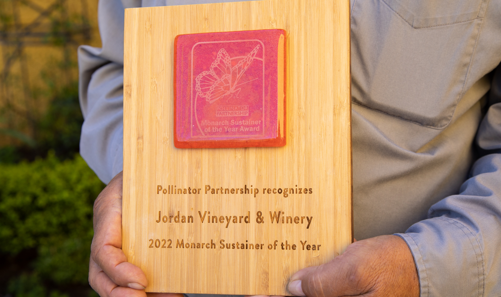 Man holding sustainability award plaque