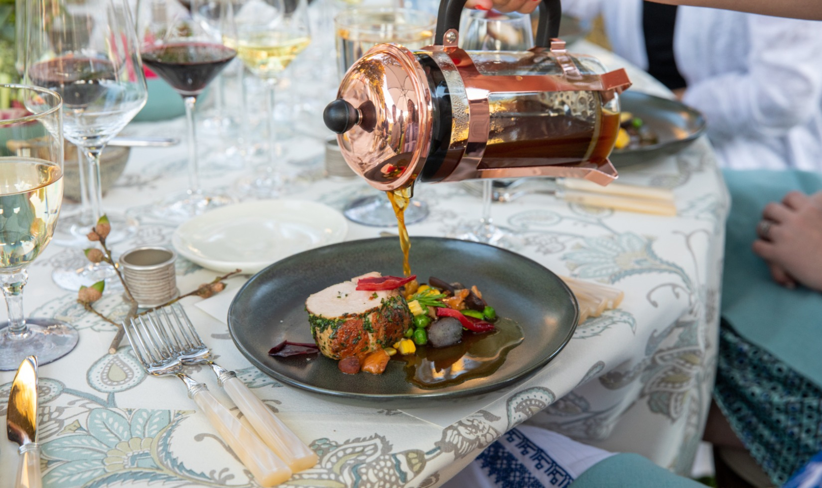 Sauce poured by server onto beef dish at Bounty of Sonoma event