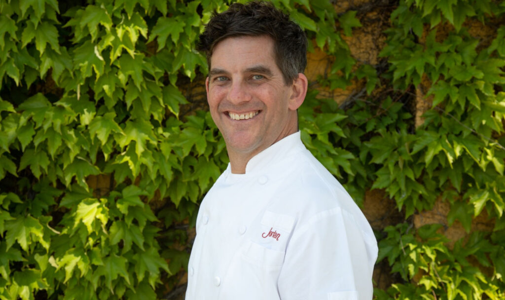 Photo of executive chef Jesse Mallgren outside an ivy-covered wall
