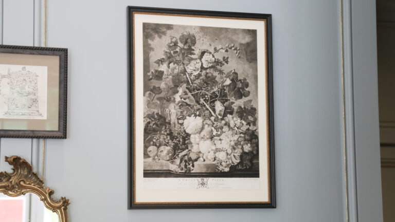 Framed image of an urn filled with flowers and pollinator plants