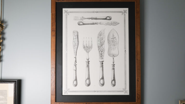 Framed image of various pieces of ornate cutlery