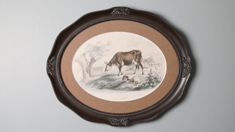 Framed drawing of a cow and calf in a meadow