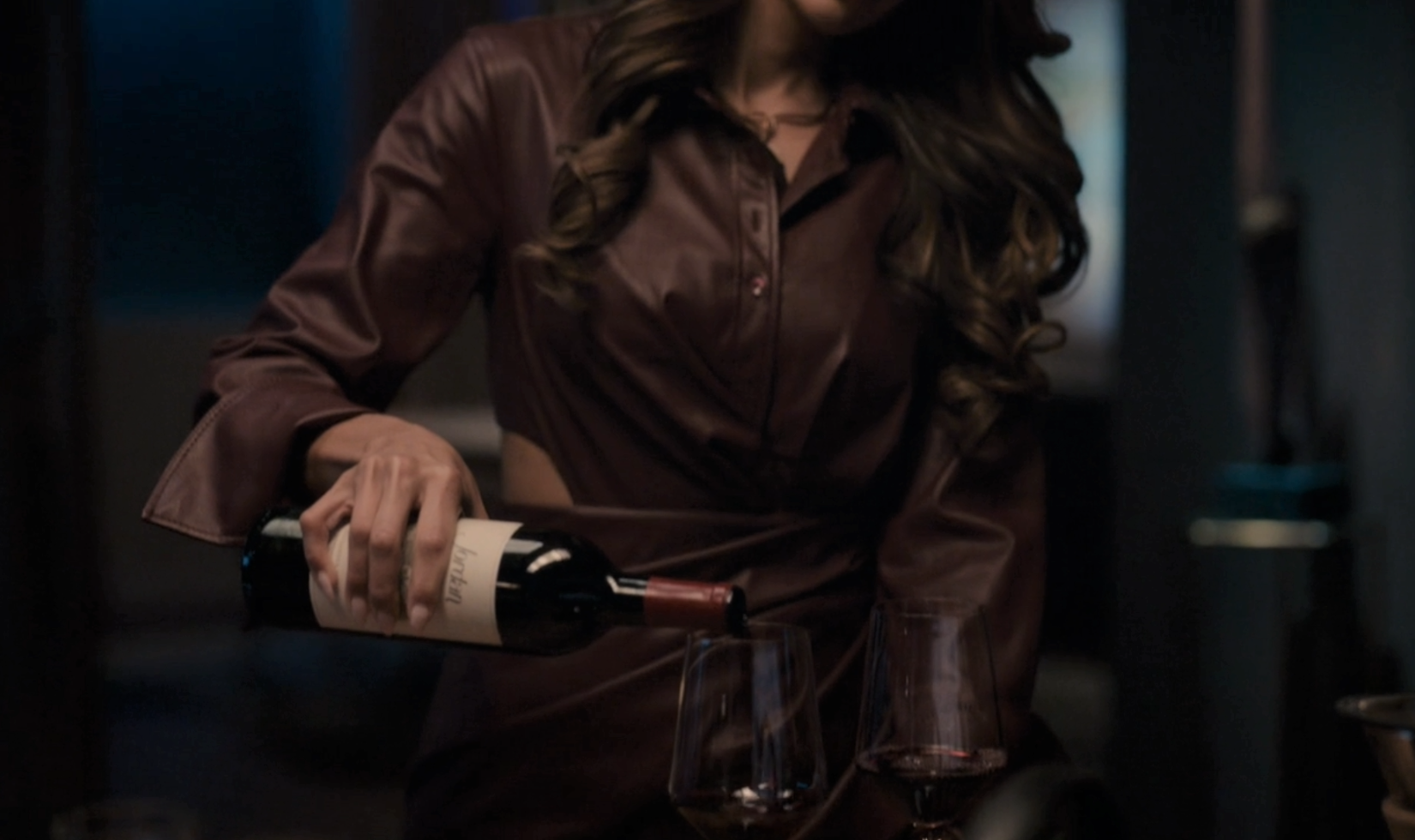 Screenshot from the TV series The Company You Keep, showing a woman pouring a glass of Jordan Cabernet Sauvignon