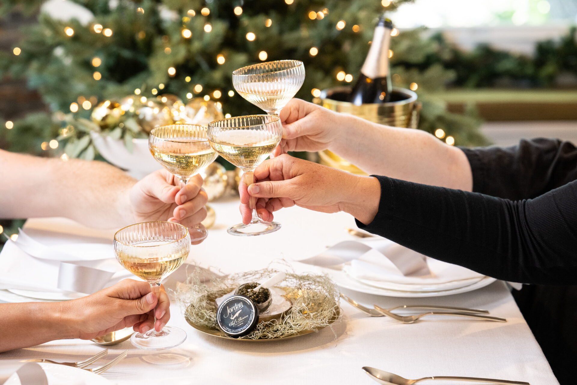 a group toasting with coups of jordan cuvee champagne