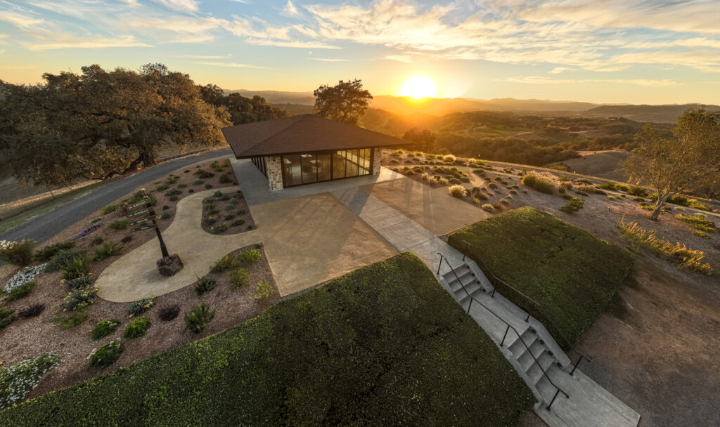 pavillion building during sunset surrounded by trees, plants and bushes