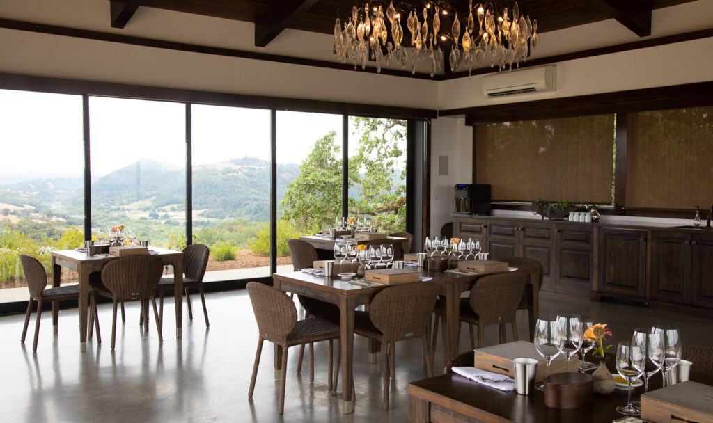 interior of glass pavillion room with views of mountains and vineyards