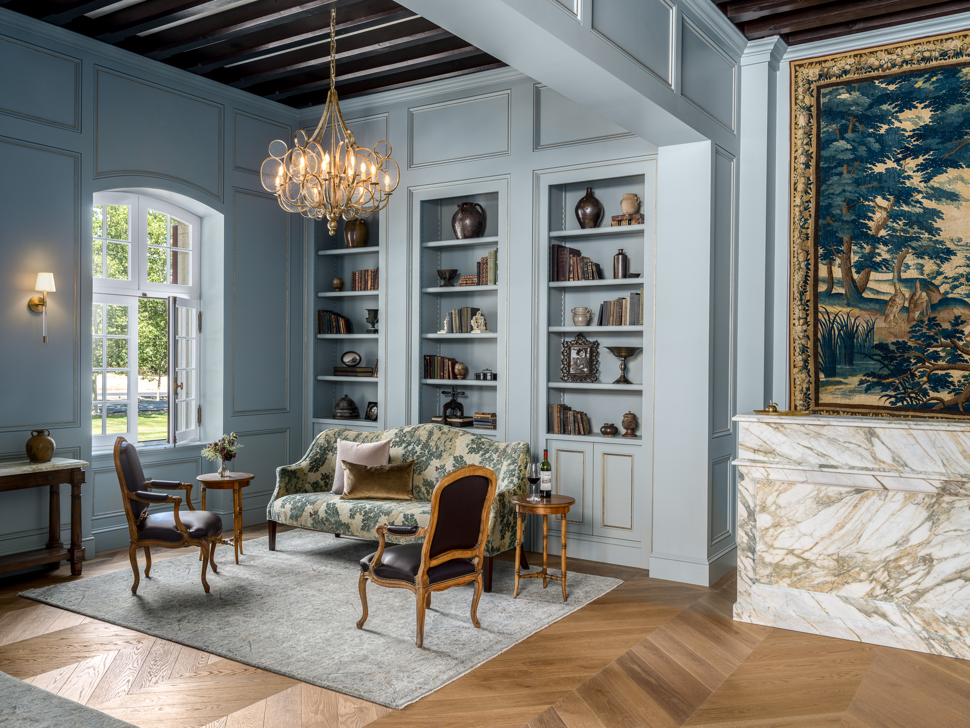 remodeled jordan lobby with antique french furniture in the lounge next to a marble desk with tapestry on a wall