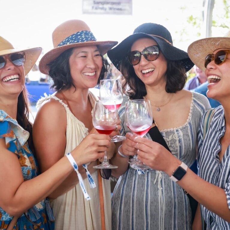 A group toasting with glasses of rosé at Healdsburg Wine & Food Experience Grand Tasting event