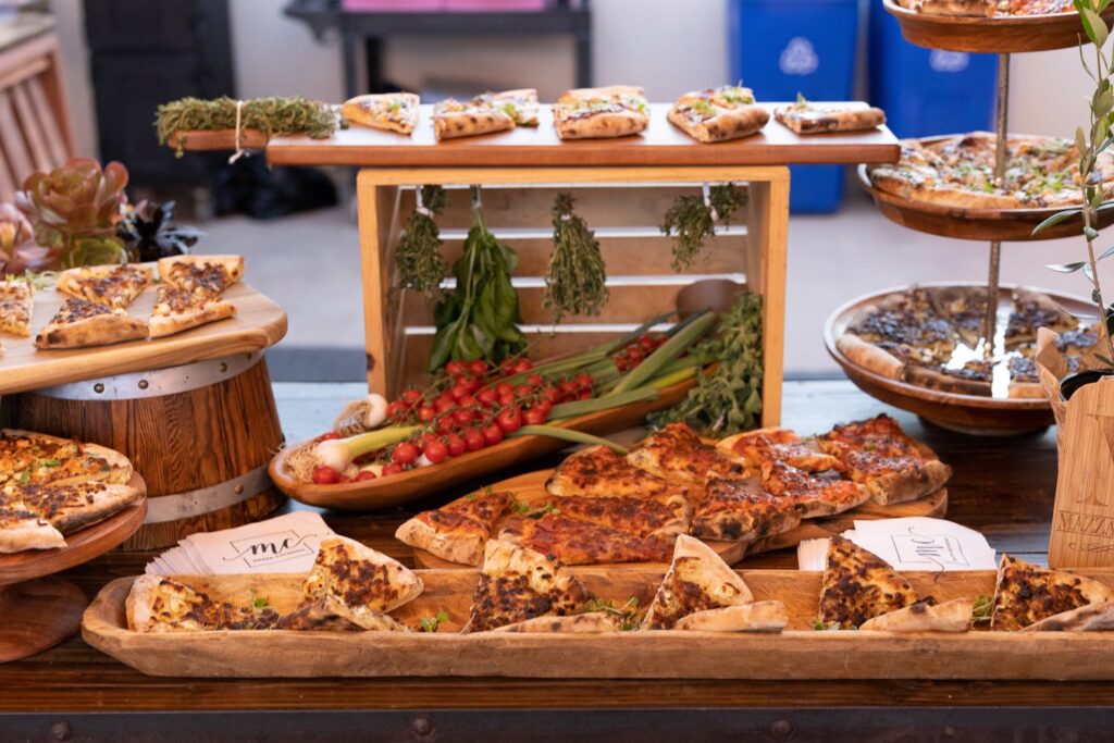 buffet table with multiple flatbread pizzas arrange on platters