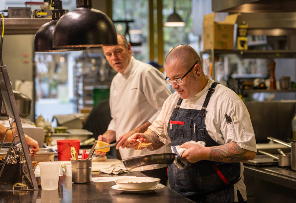 chefs cooking in kitchen at formal restaurant