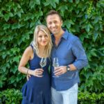 A couple in front of the ivy at Jordan Winery in wine country casual attire